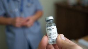 Hand holding insulin vial