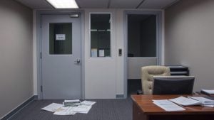 Closed nonprofit office with empty chair and documents