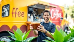 Coffee truck serving drinks with a smiling barista.