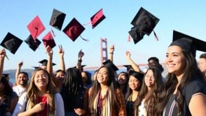 MacKenzie Scott with happy Bay Area students outdoors