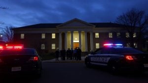 Courthouse with police cars and concerned people